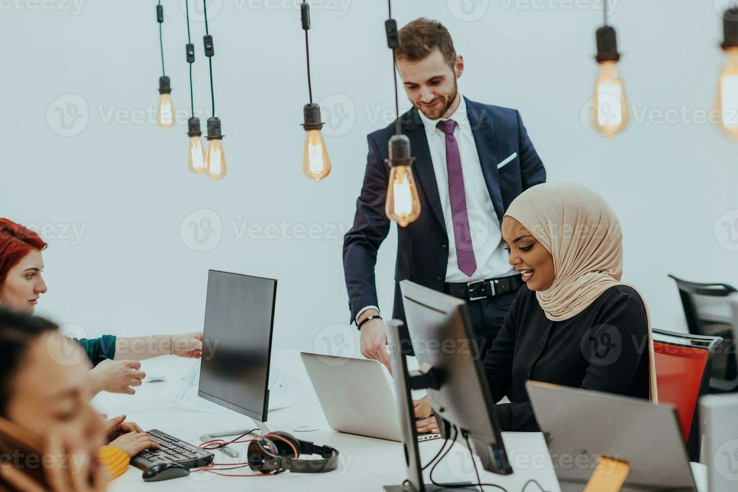 Multiethnic group of employees working in a marketing company. A group of colleagues is working on a project in modern offices photo