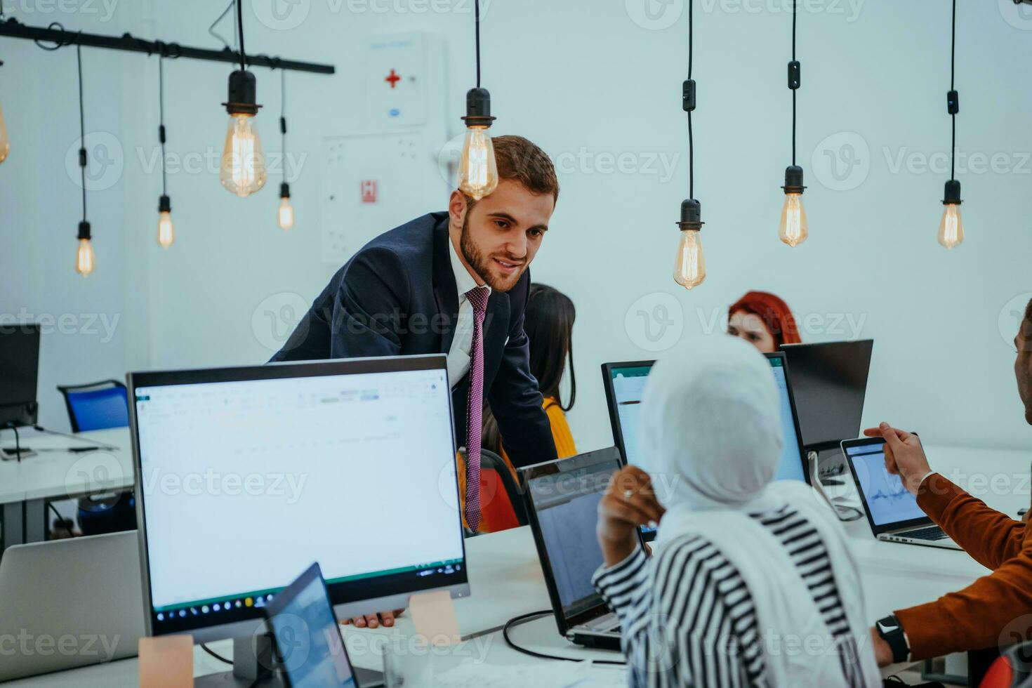 Multiethnic group of employees working in a marketing company. A group of colleagues is working on a project in modern offices photo