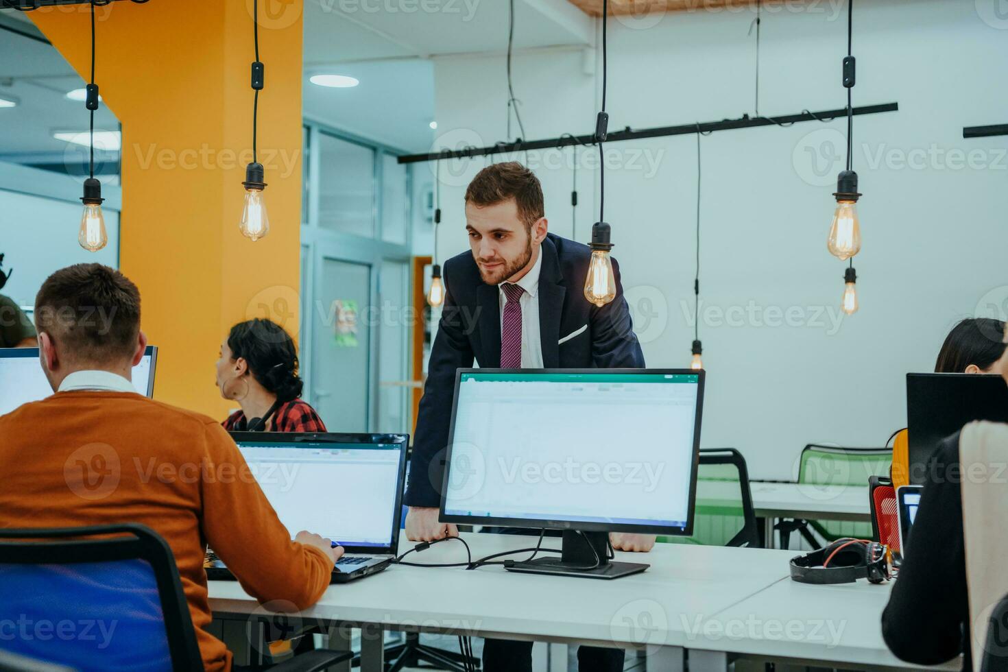 Multiethnic group of employees working in a marketing company. A group of colleagues is working on a project in modern offices photo