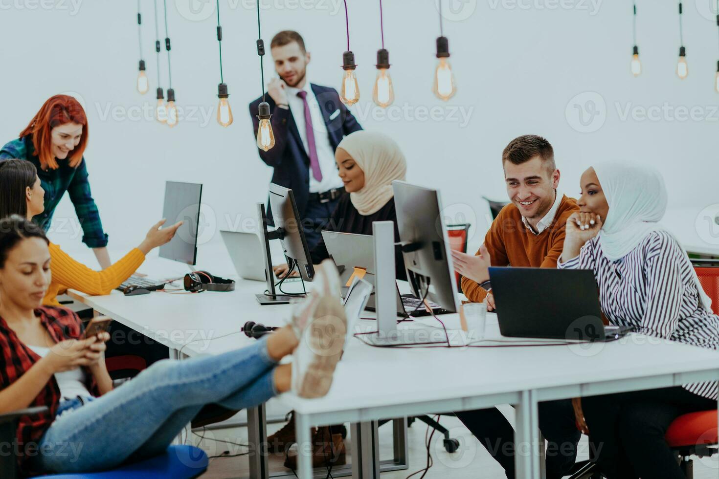 Multiethnic group of employees working in a marketing company. A group of colleagues is working on a project in modern offices photo