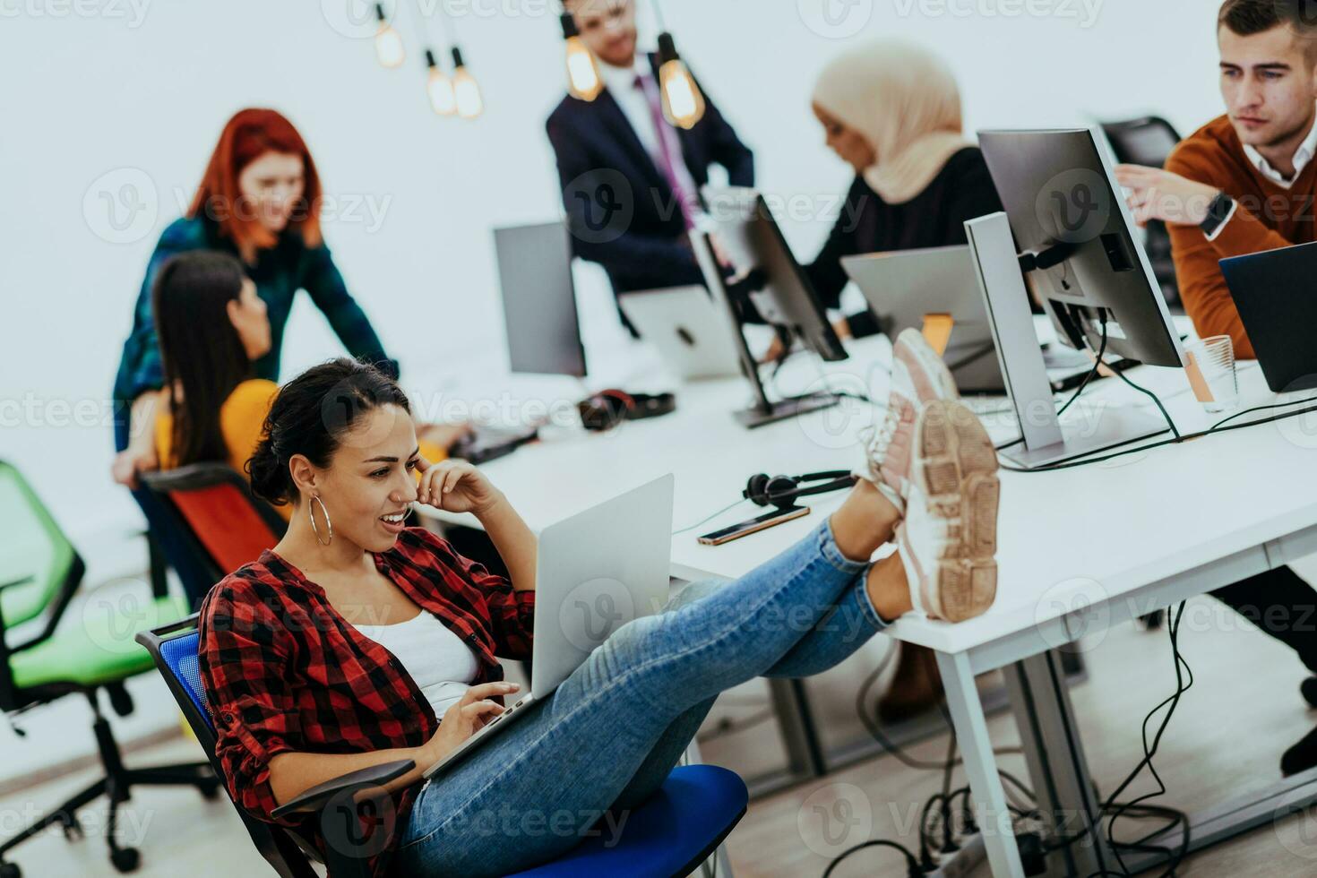 Multiethnic group of employees working in a marketing company. A group of colleagues is working on a project in modern offices photo