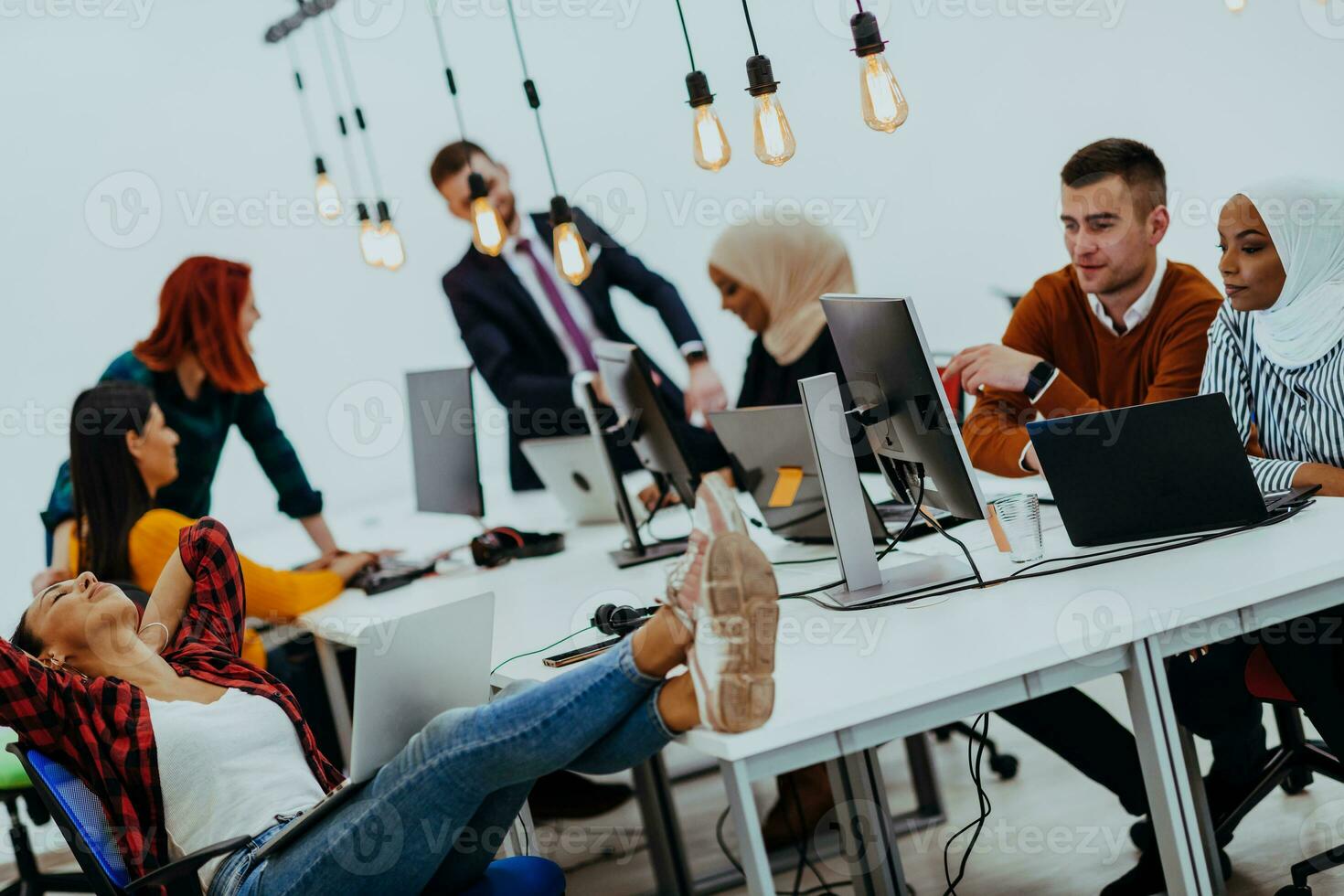 Multiethnic group of employees working in a marketing company. A group of colleagues is working on a project in modern offices photo
