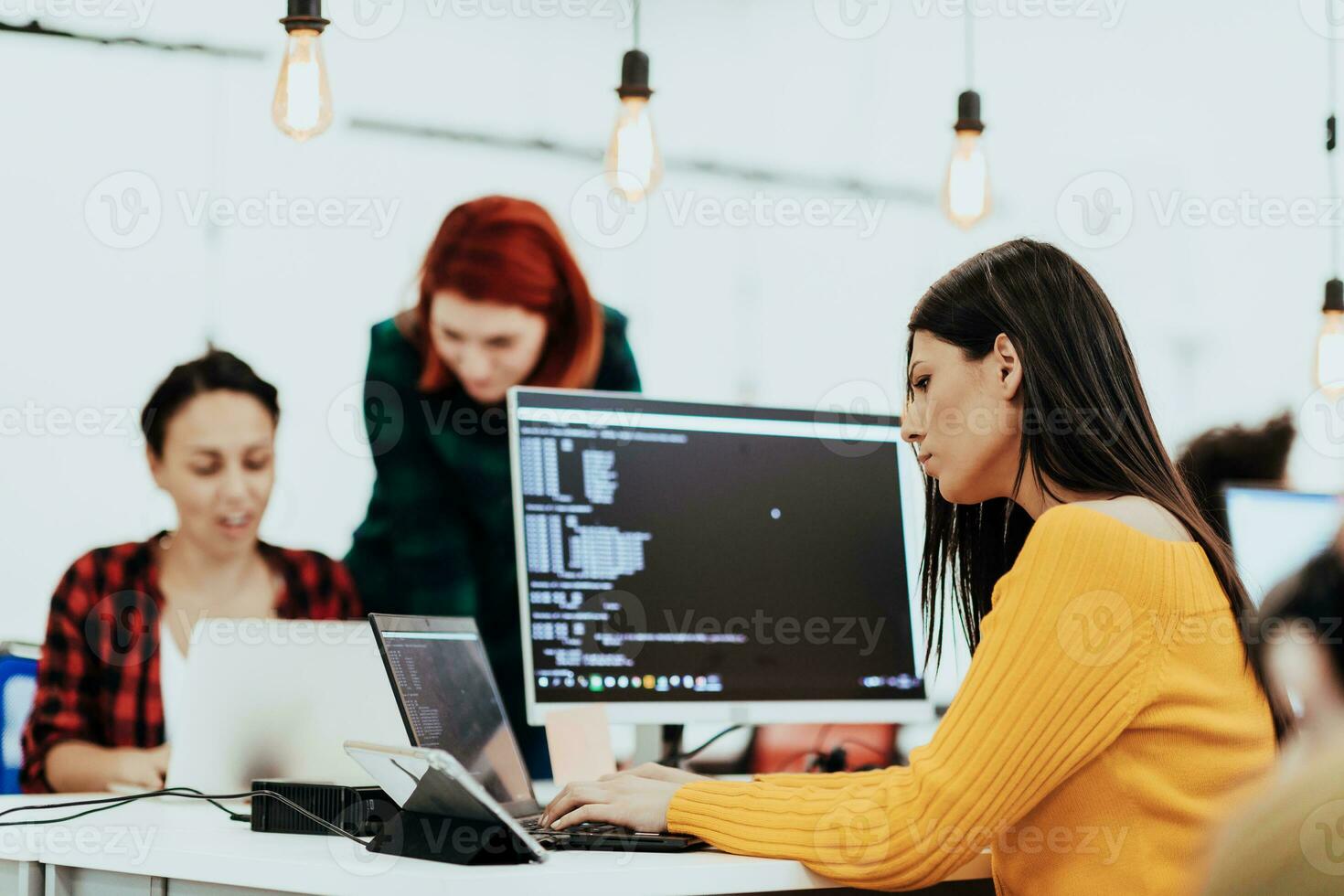 Multiethnic group of employees working in a marketing company. A group of colleagues is working on a project in modern offices photo