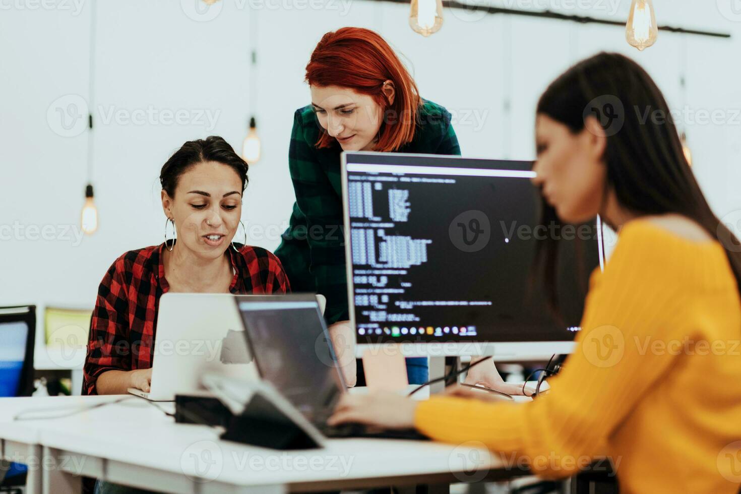 Multiethnic group of employees working in a marketing company. A group of colleagues is working on a project in modern offices photo