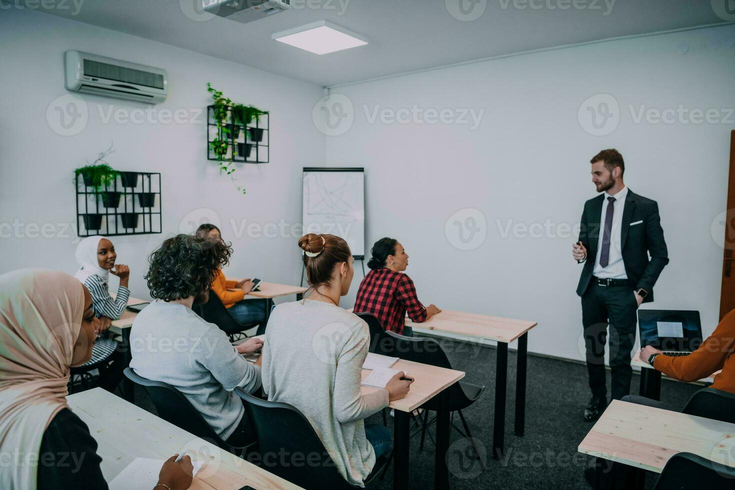 Group of young diverse people gathered together having a work presentation on whiteboard photo