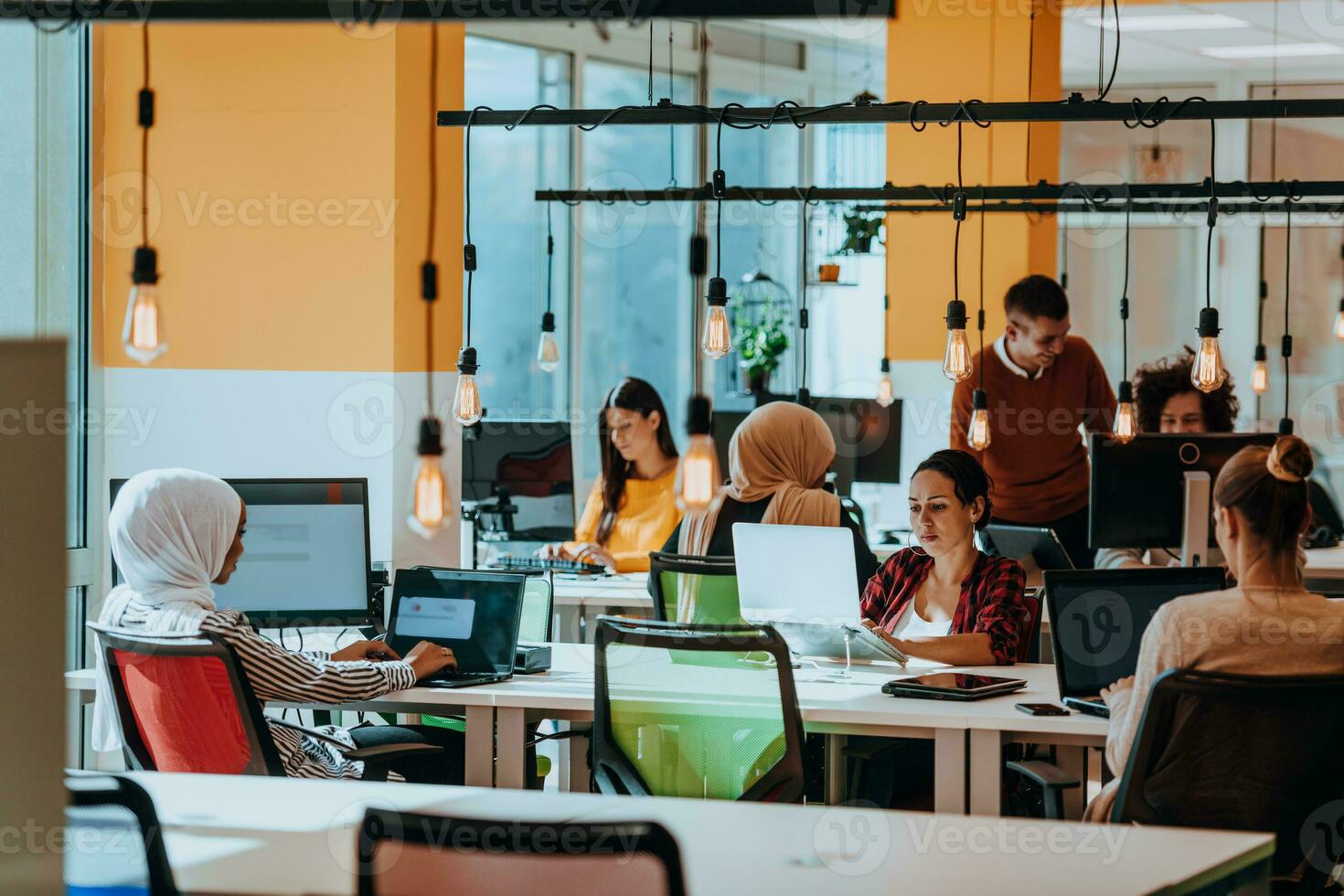 Multiethnic group of employees working in a marketing company. A group of colleagues is working on a project in modern offices photo