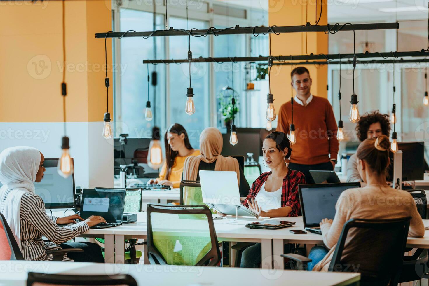 Multiethnic group of employees working in a marketing company. A group of colleagues is working on a project in modern offices photo