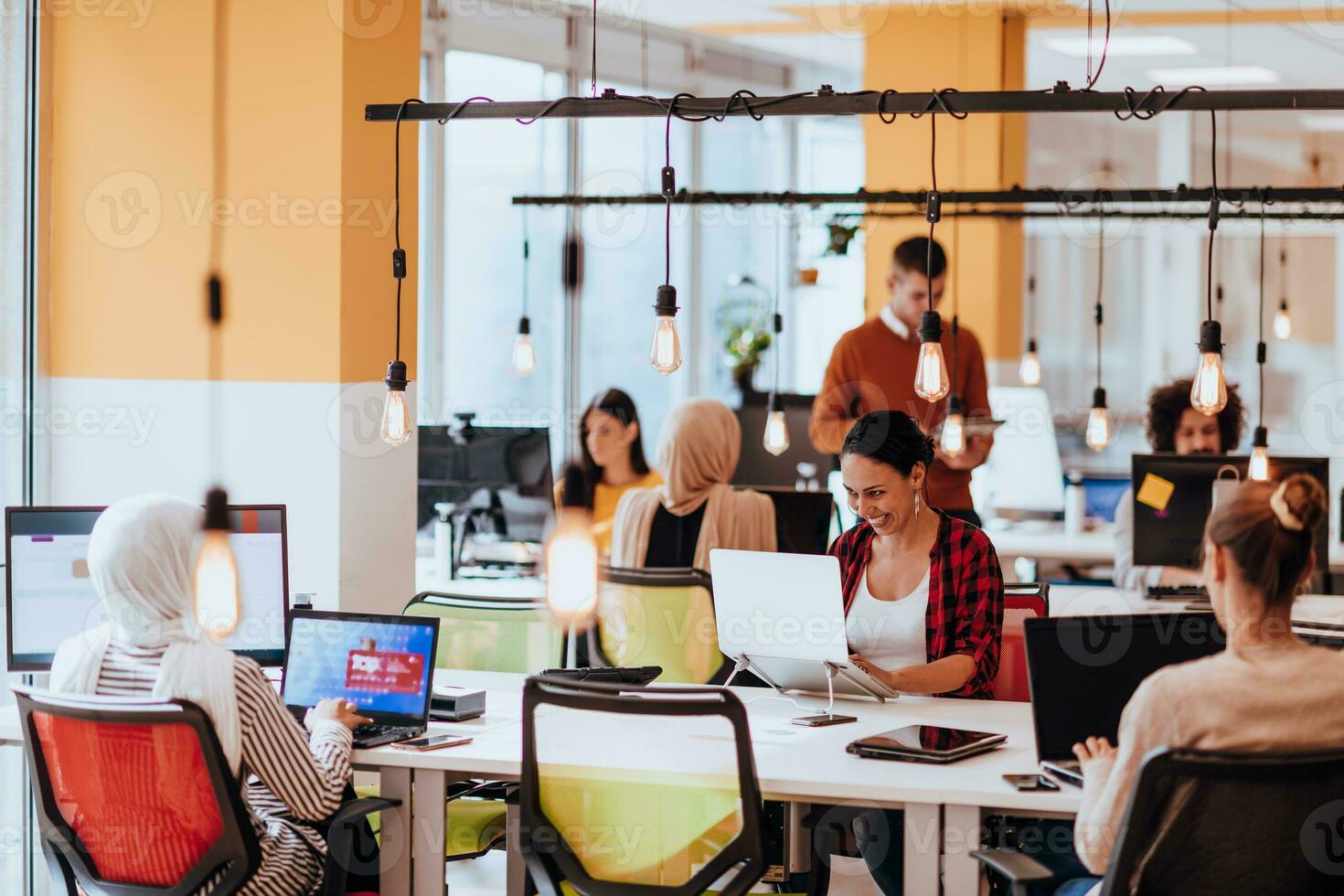 Multiethnic group of employees working in a marketing company. A group of colleagues is working on a project in modern offices photo