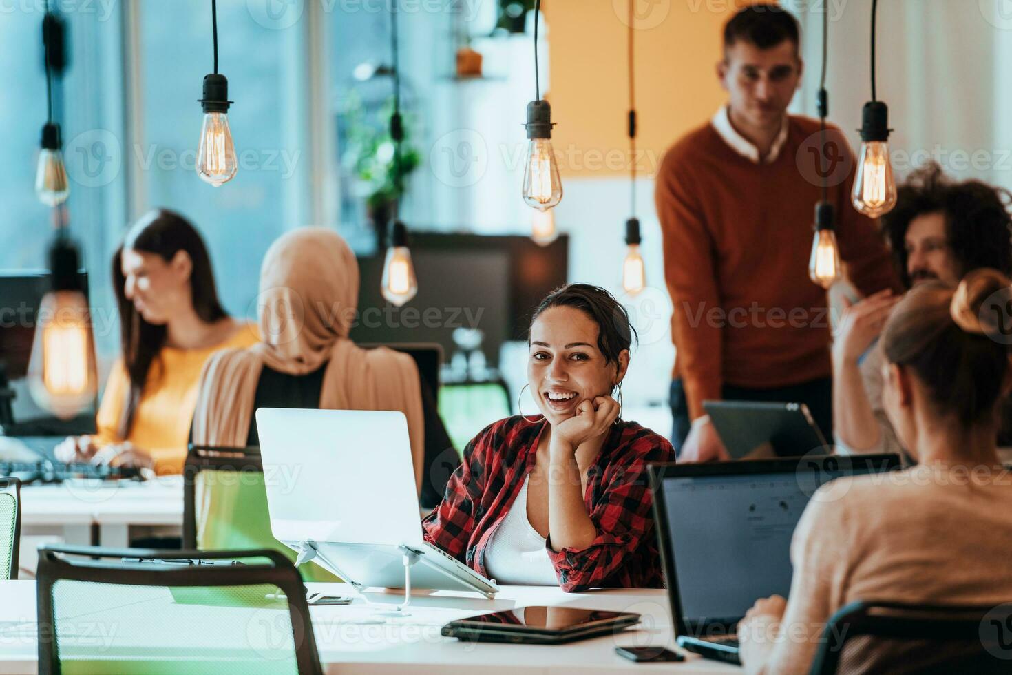 Multiethnic group of employees working in a marketing company. A group of colleagues is working on a project in modern offices photo
