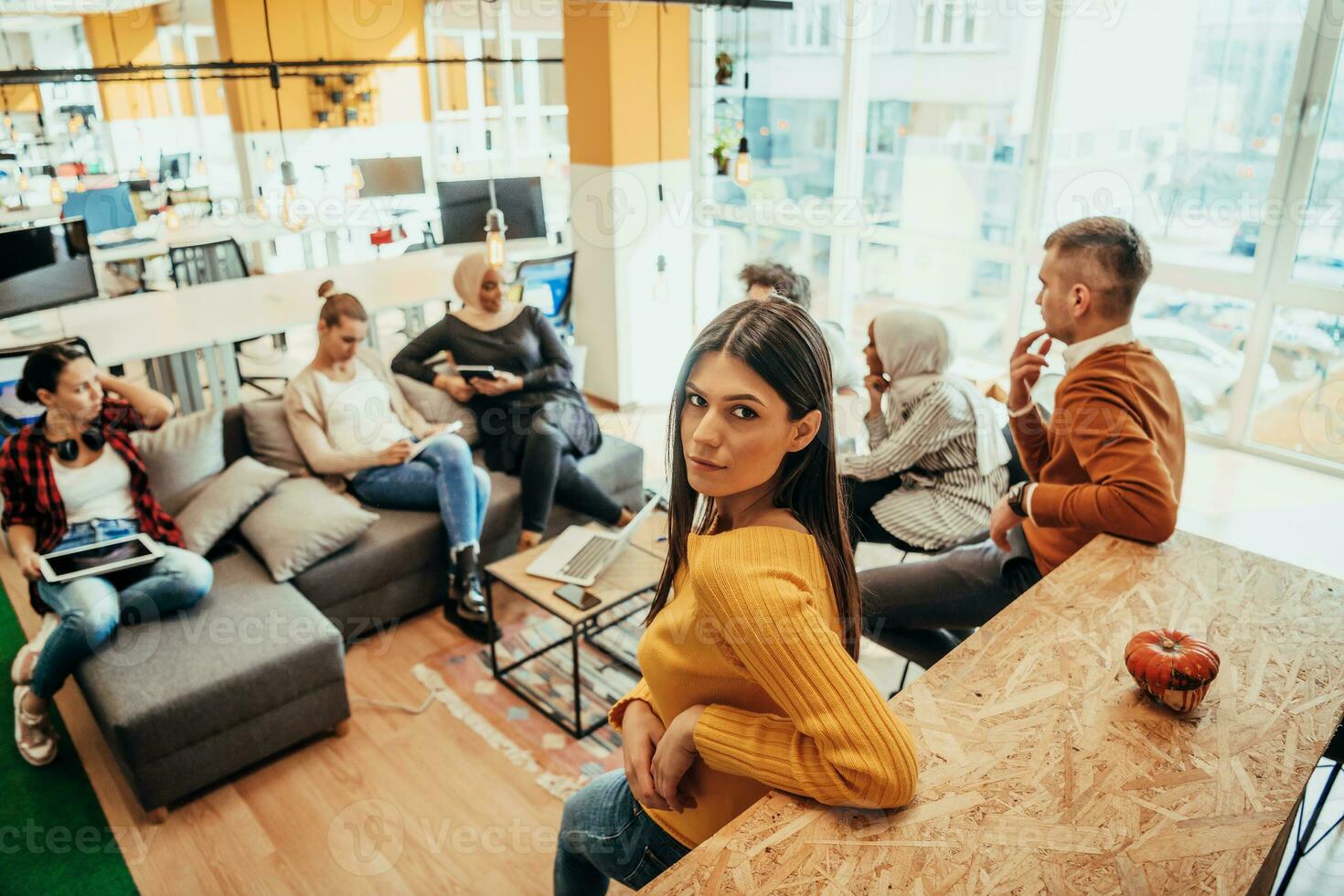 Young designer giving some new ideas about project to his partners in conference room. Business people discussing over new business project in office. photo