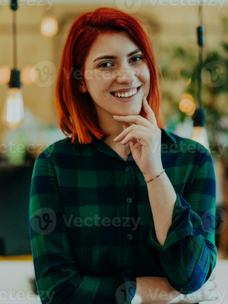 Headshot portrait of a modern woman in the office at night by the window photo