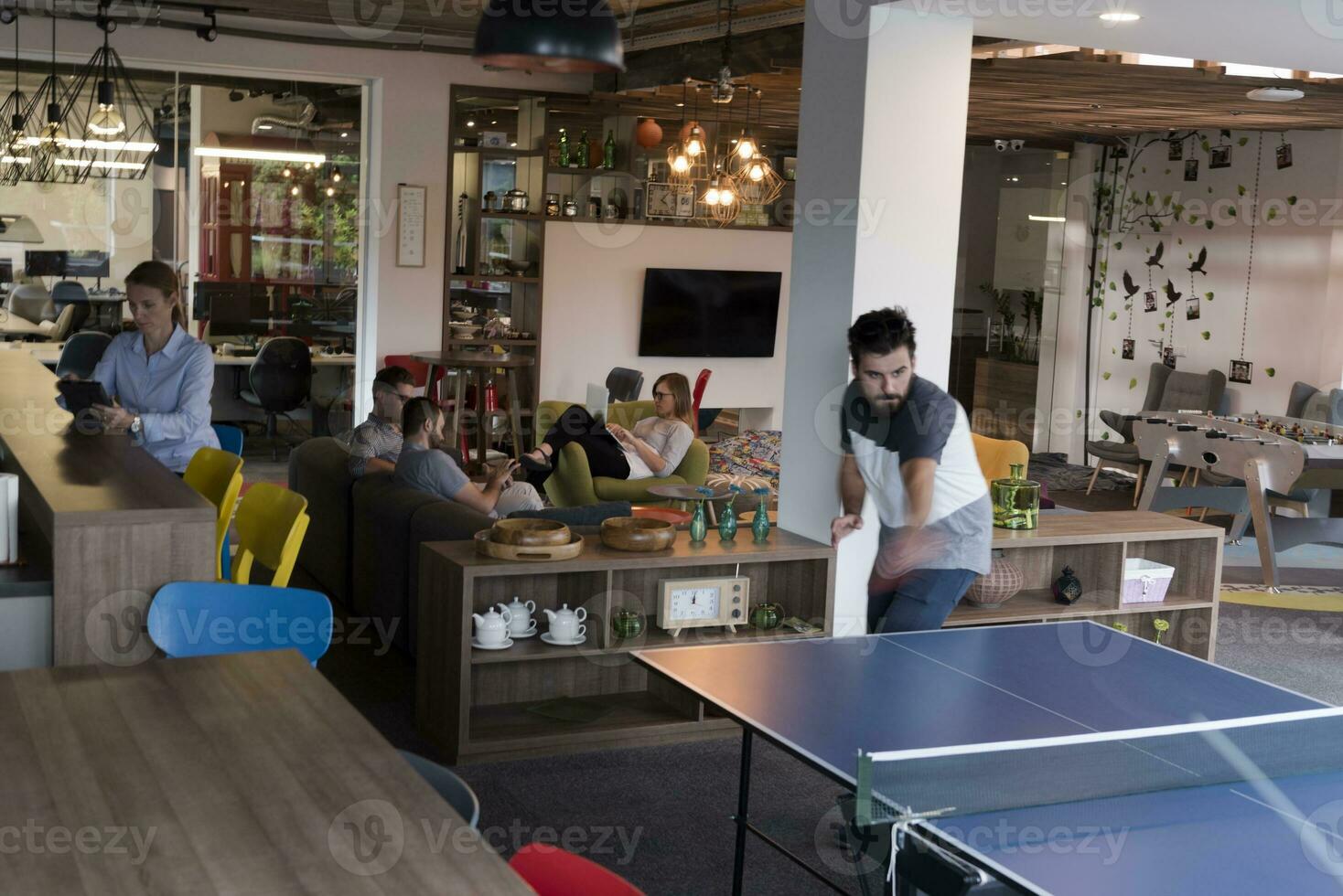 playing ping pong tennis at creative office space photo