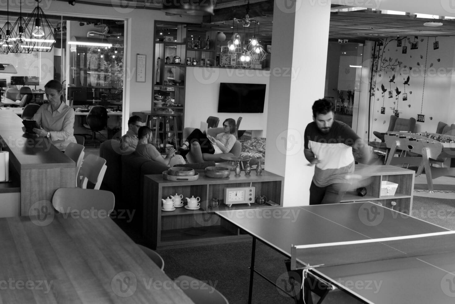 playing ping pong tennis at creative office space photo