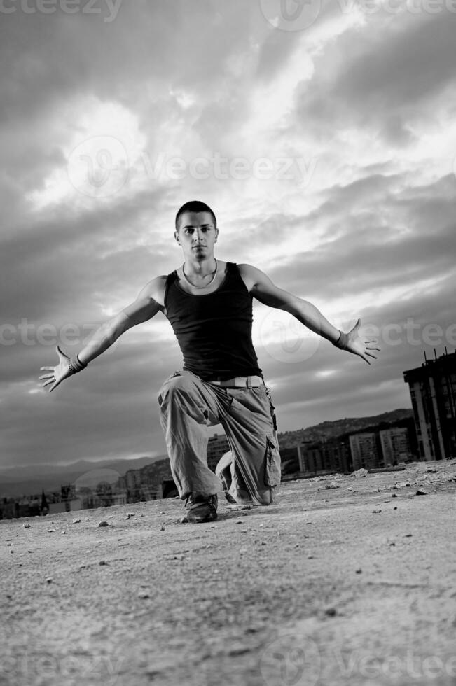 young man jumping in air outdoor at night ready to party photo