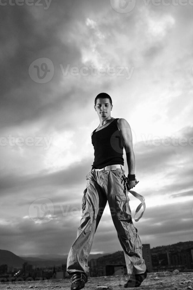 young man dancing and jumping  on top of the building photo