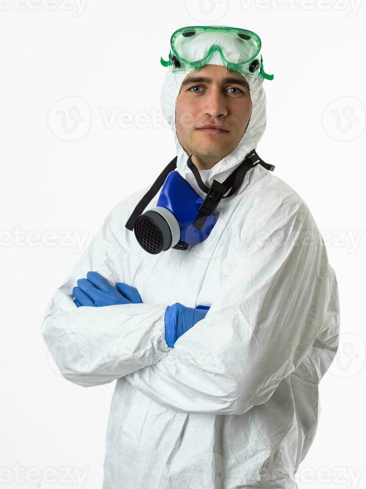 Doctor wearing protective biological suit and mask due to coronavirus 2019-nCoV global pandemic warning and danger background against white background. photo