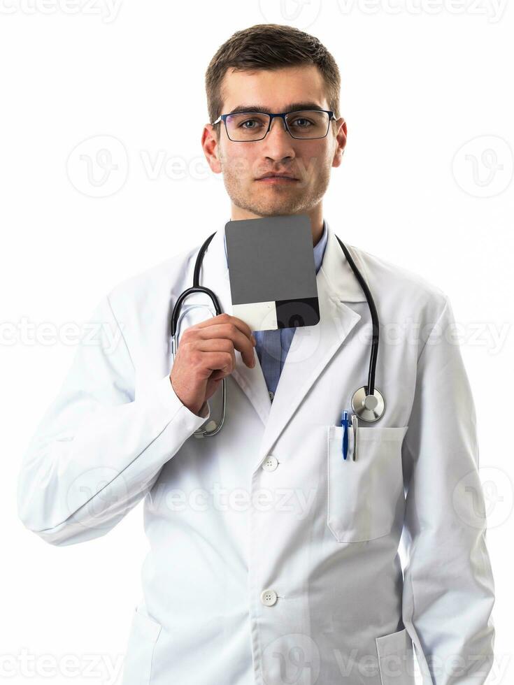 Confident male doctor in white lab coat and stethoscope standing with folded arms smiling at the camera isolated on white photo