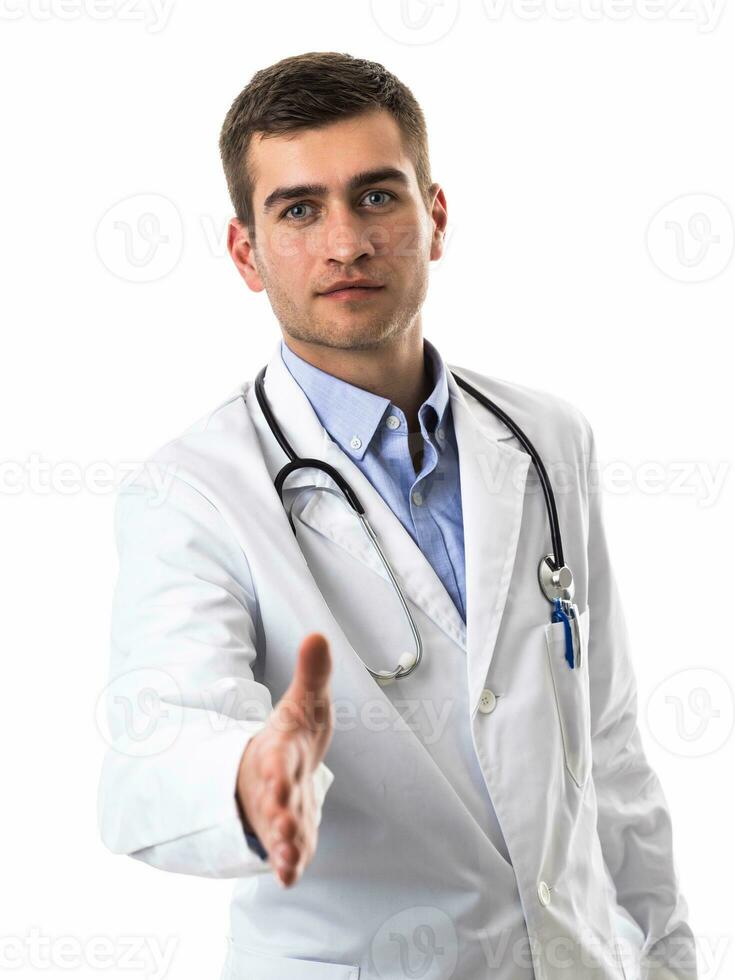 Portrait of a doctor holding out his hand as a support to a patient isolated on a white background photo