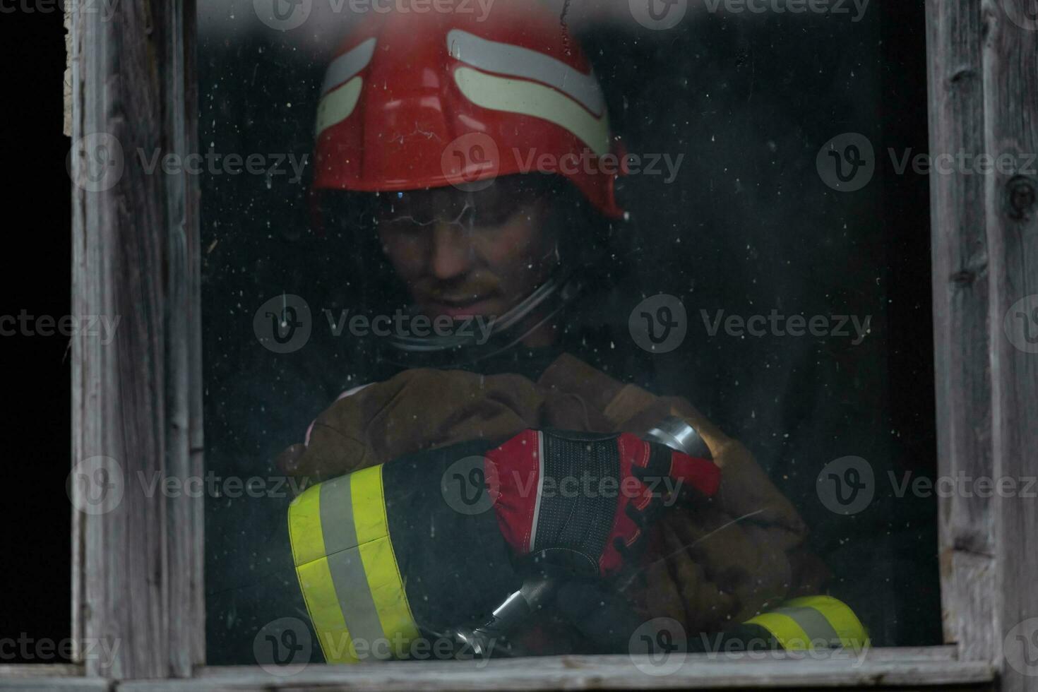 Firefighter hero carrying baby girl out from burning building area from fire incident. Rescue people from dangerous place photo