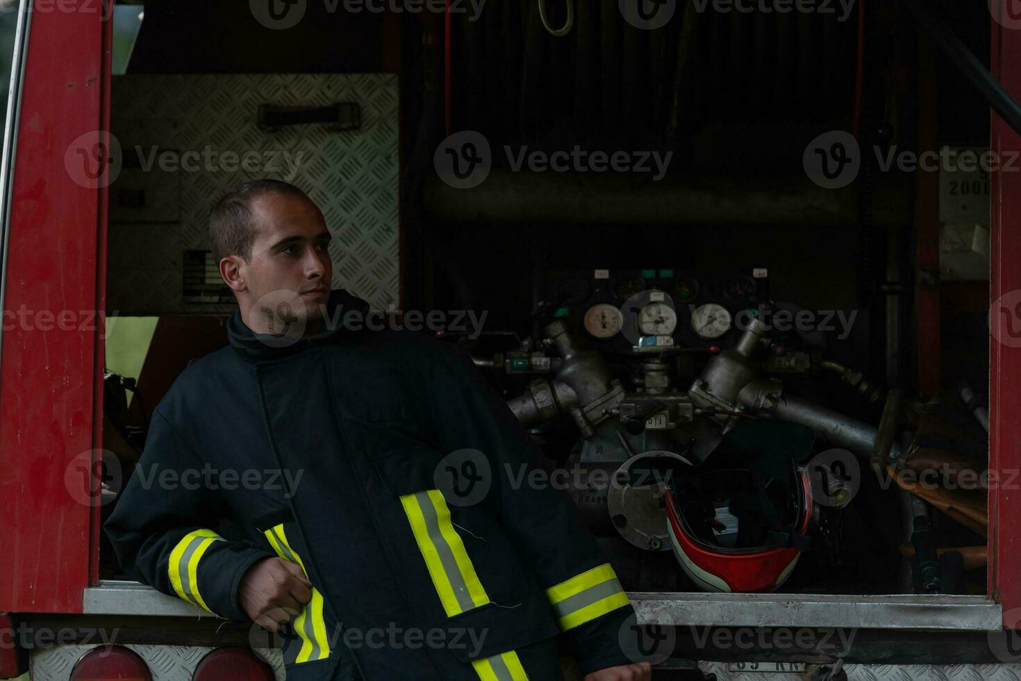 depressed and tired firefighter near fire truck. photo