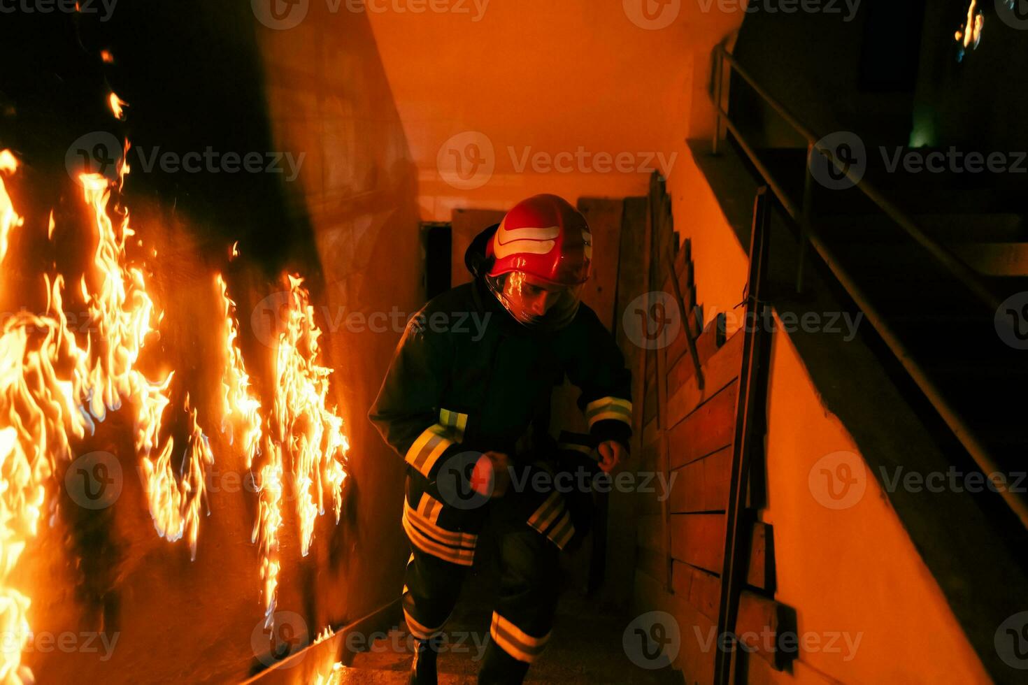 Brave Fireman going upstairs to save and rescue people in a Burning Building. Open fire and flame. photo