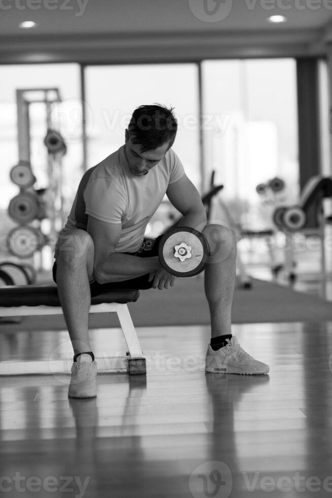 handsome man working out with dumbbells photo