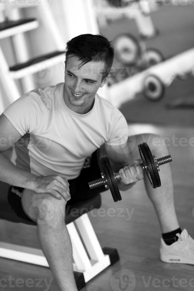 handsome man working out with dumbbells photo