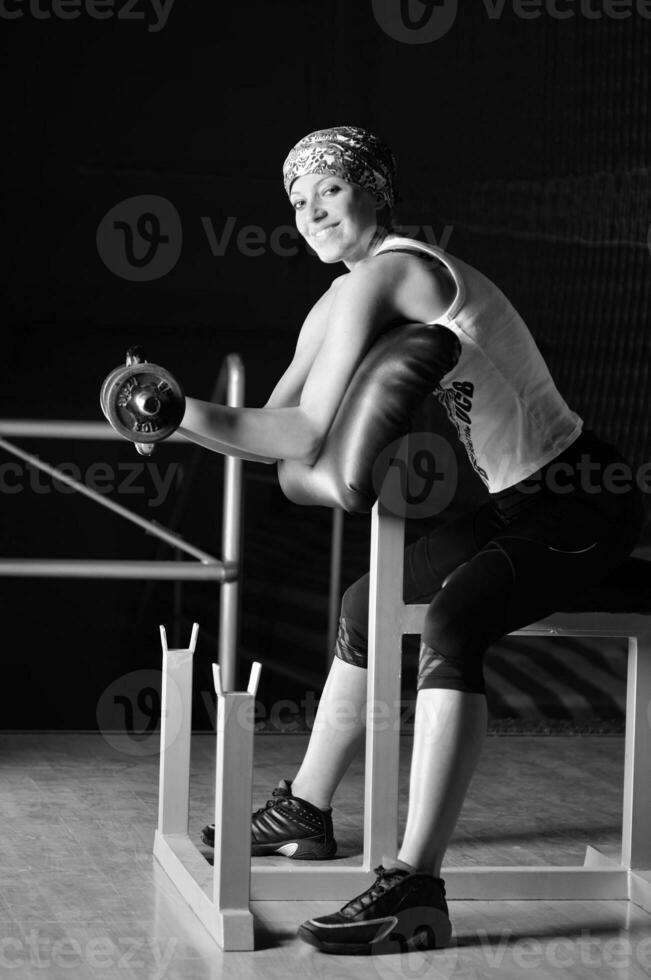 young woman practicing fitness and working out photo