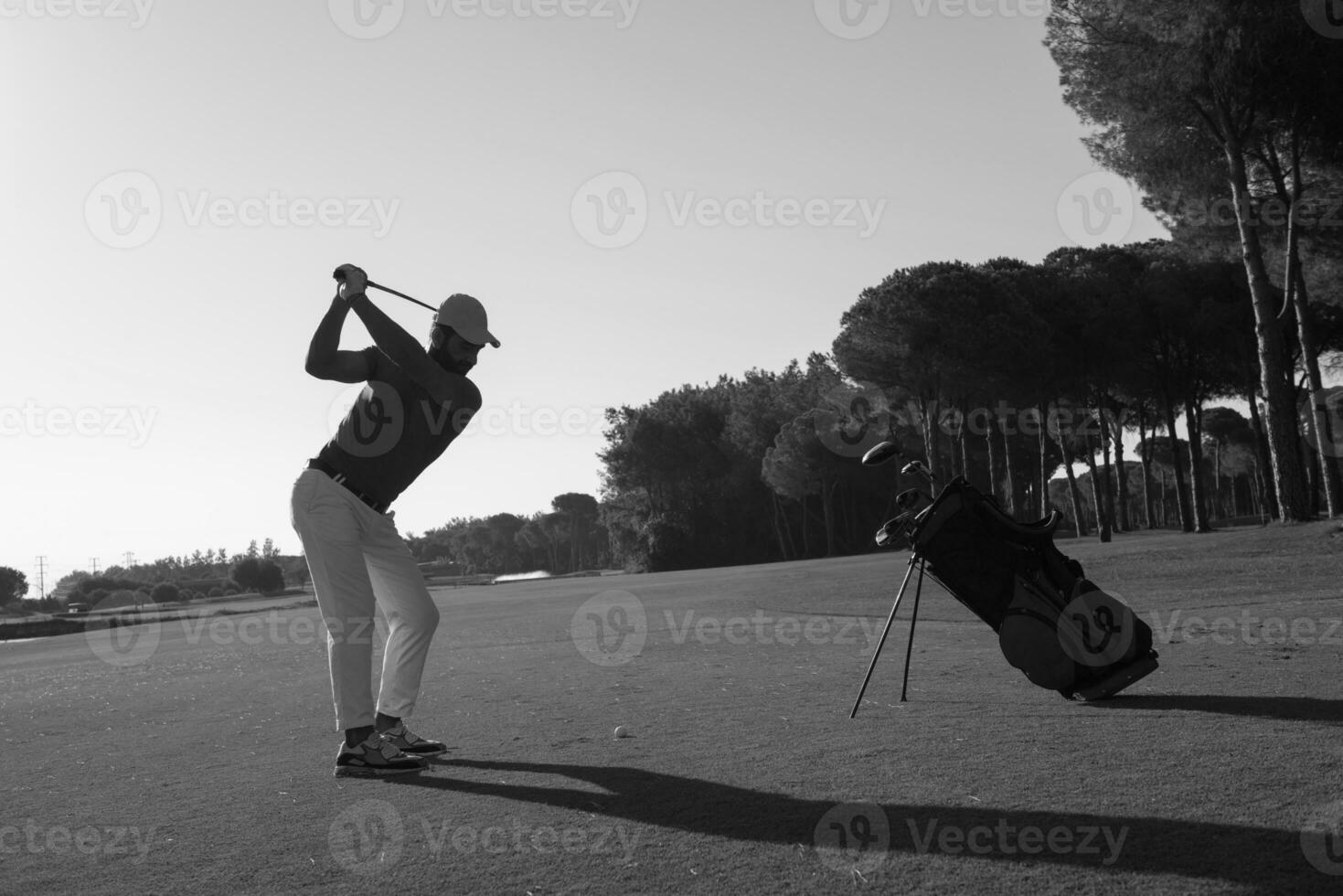 golf player hitting shot photo