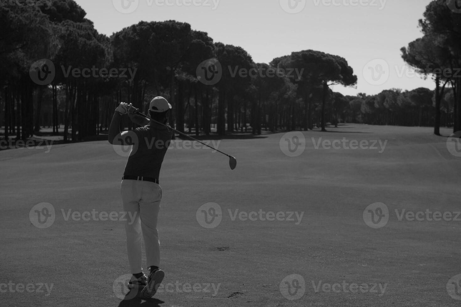 golf player hitting shot photo