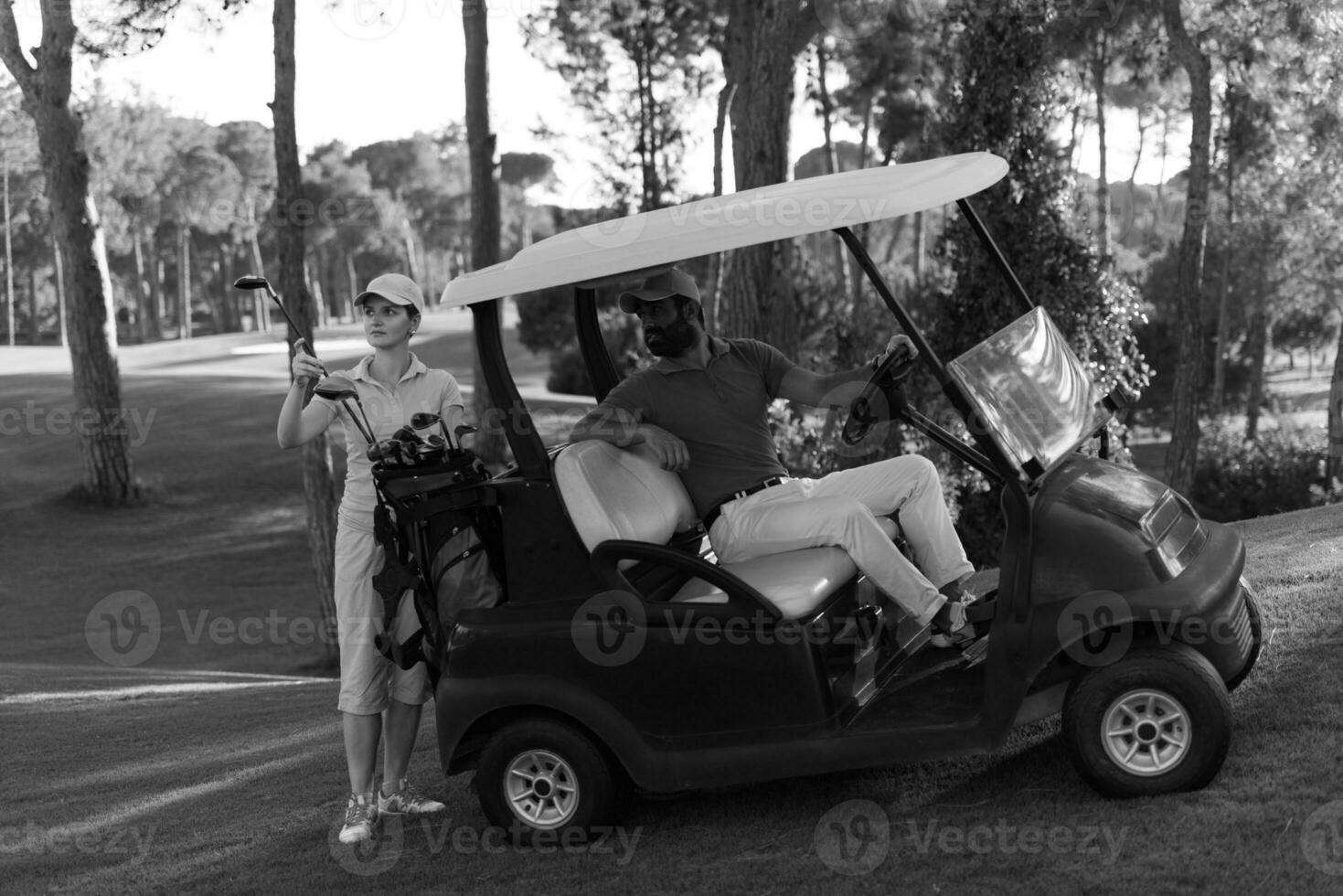 couple in buggy on golf course photo