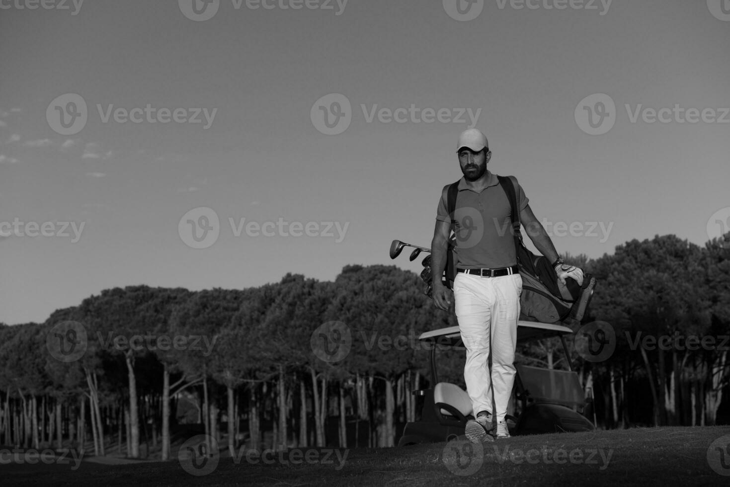 golfer  walking and carrying golf  bag photo