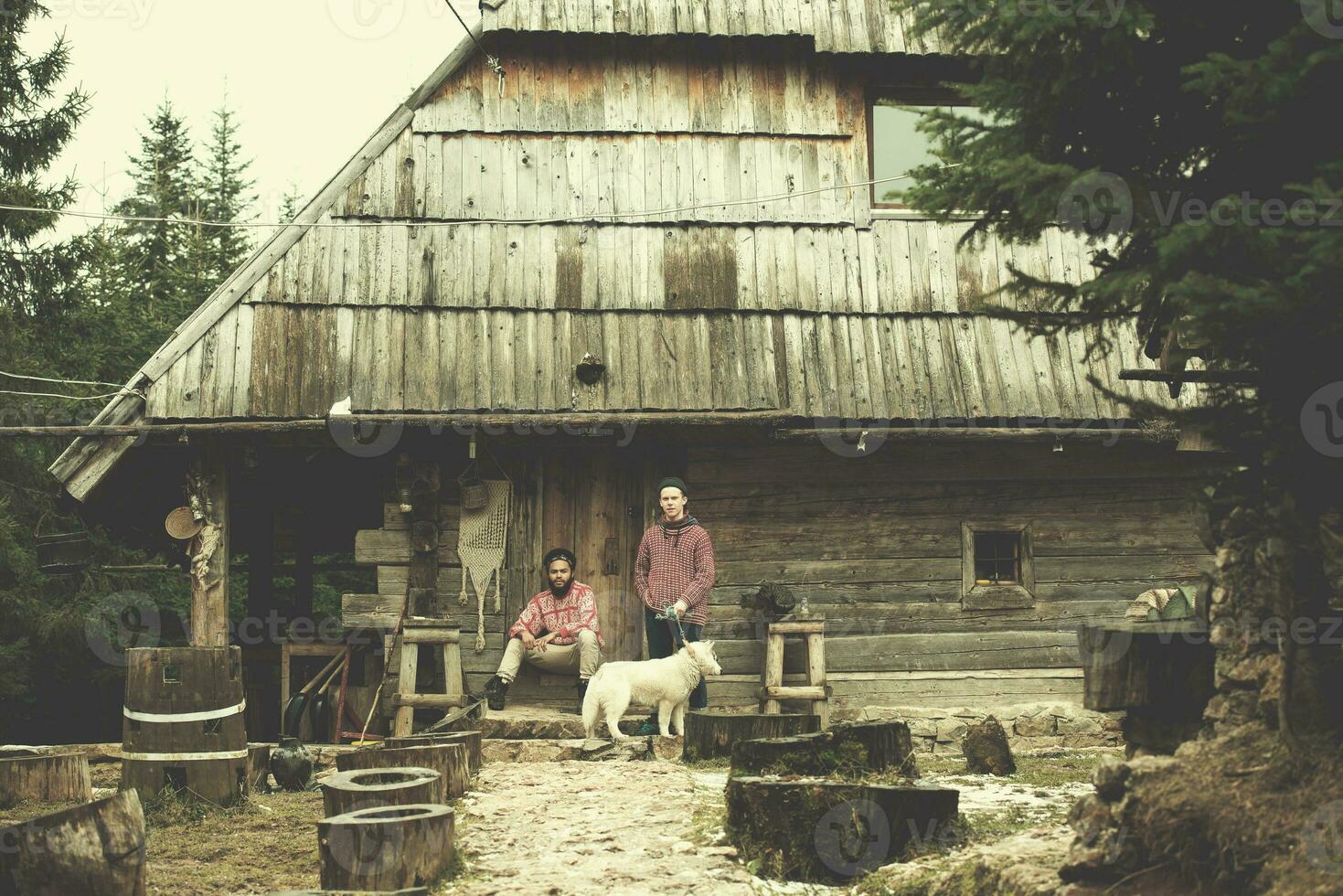 frineds together in front of old wooden house photo