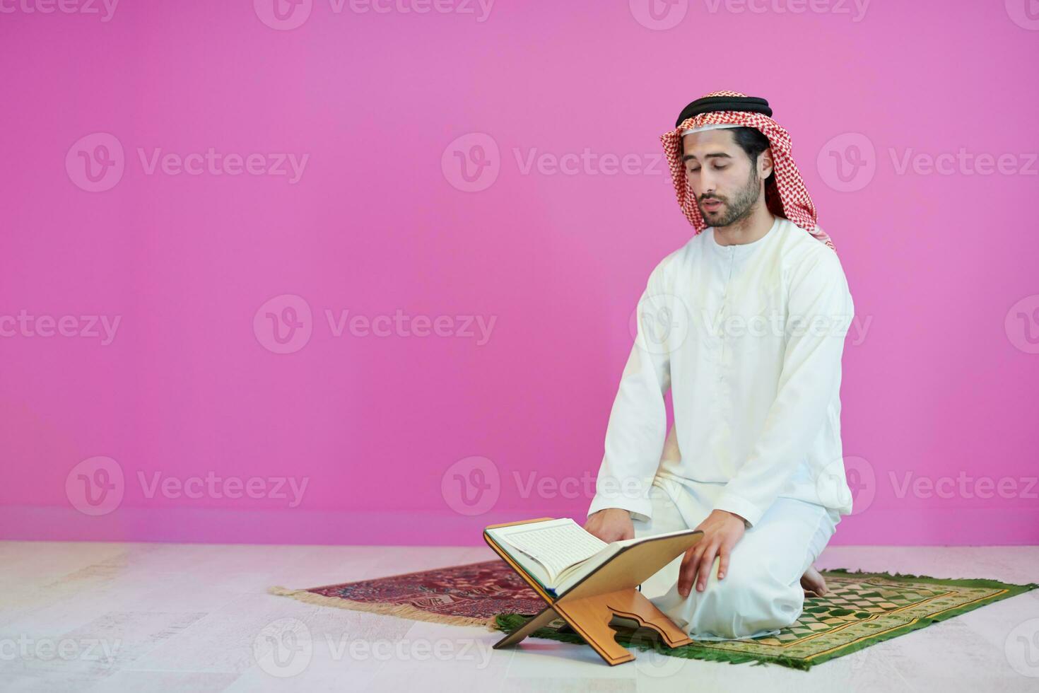 young arabian muslim man reading Quran at home photo