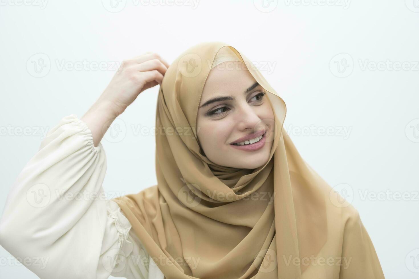 Portrait of young muslim woman wearing hijab on isolated white background photo