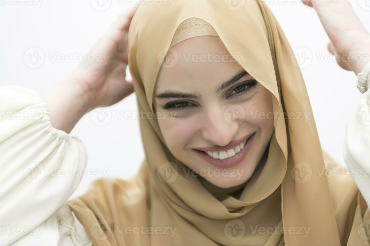 Portrait of young muslim woman wearing hijab on isolated white background photo