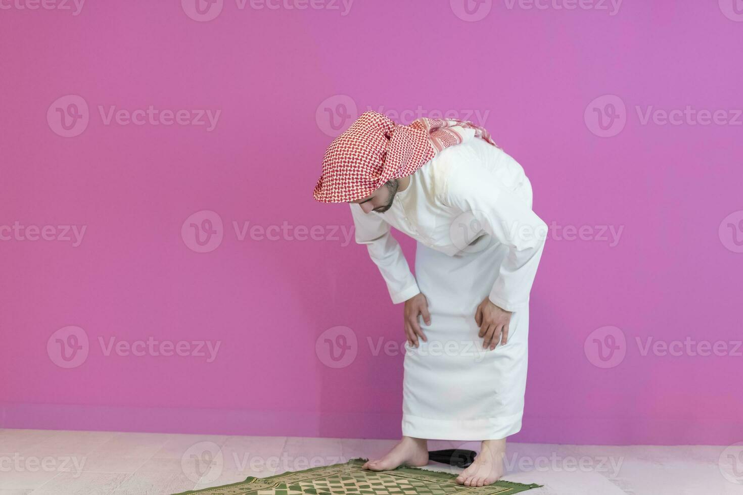 Young muslim man praying salat during Ramadan photo