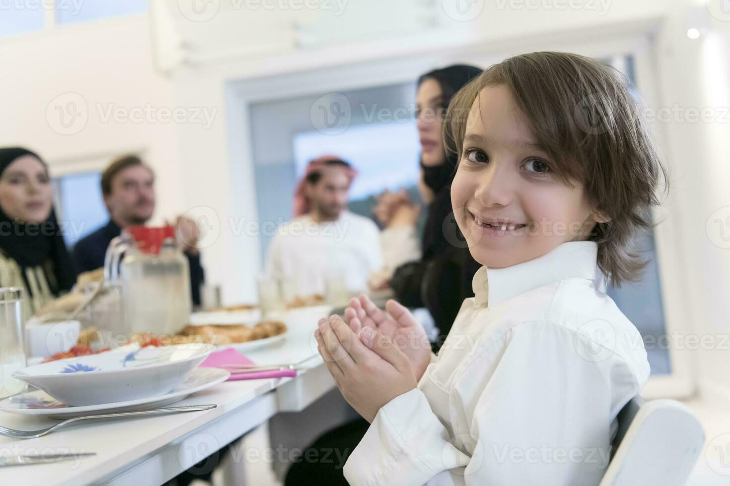 Muslim family making iftar dua to break fasting during Ramadan. photo