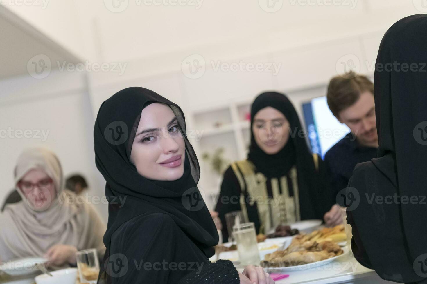 Muslim family making iftar dua to break fasting during Ramadan. photo