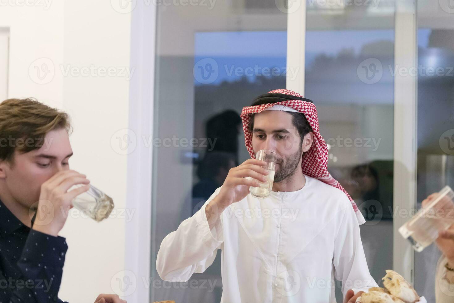 Muslim family making iftar dua to break fasting during Ramadan. photo