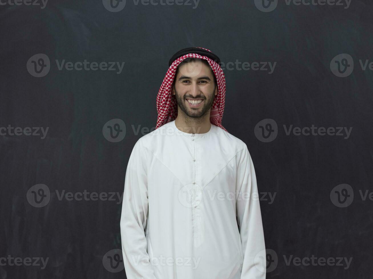 Portrait of young muslim man wearing traditional clothes photo