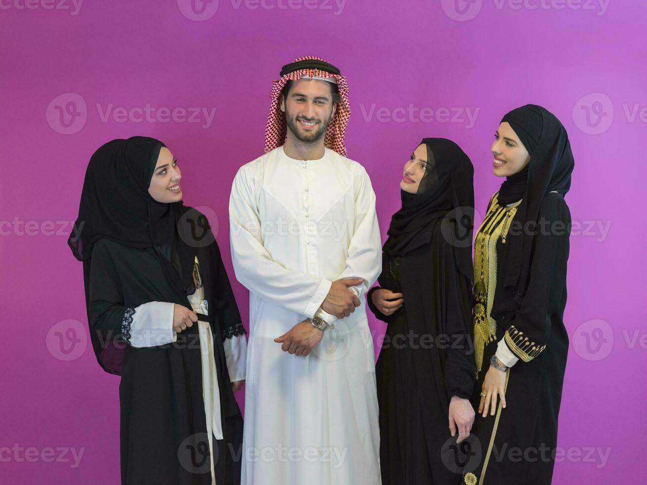 Group portrait of young Muslim people Arabian men with three Muslim women in a fashionable dress photo