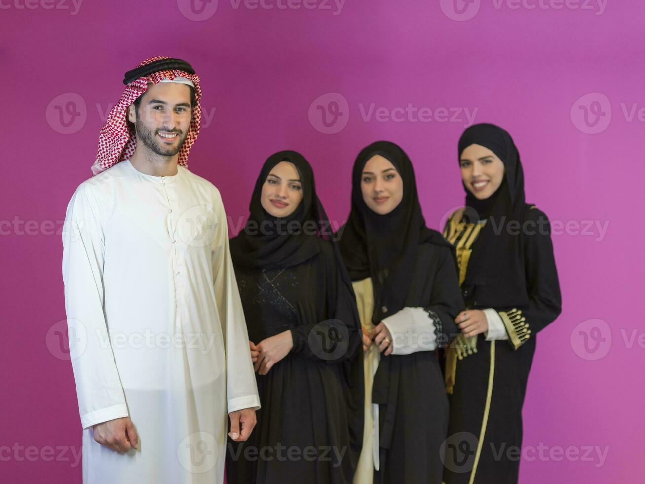 Group portrait of young Muslim people Arabian men with three Muslim women in a fashionable dress photo