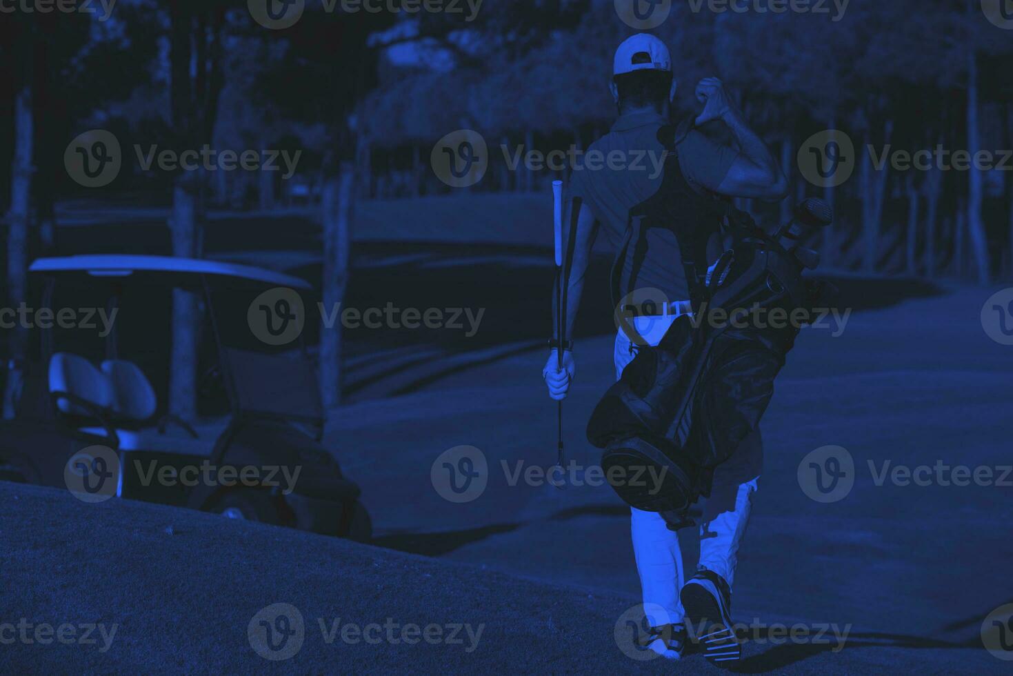 golfer  walking and carrying golf  bag photo