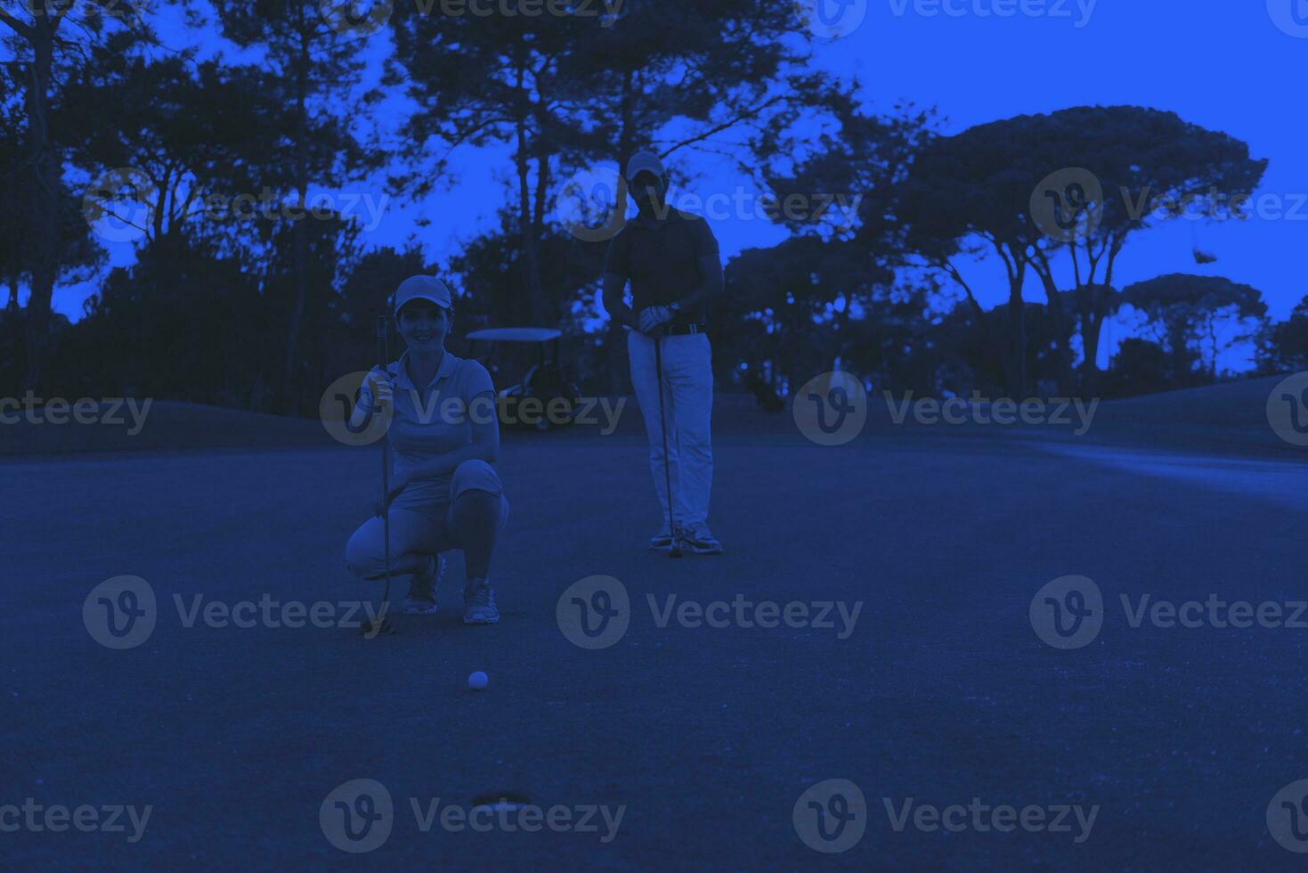 couple on golf course at sunset photo