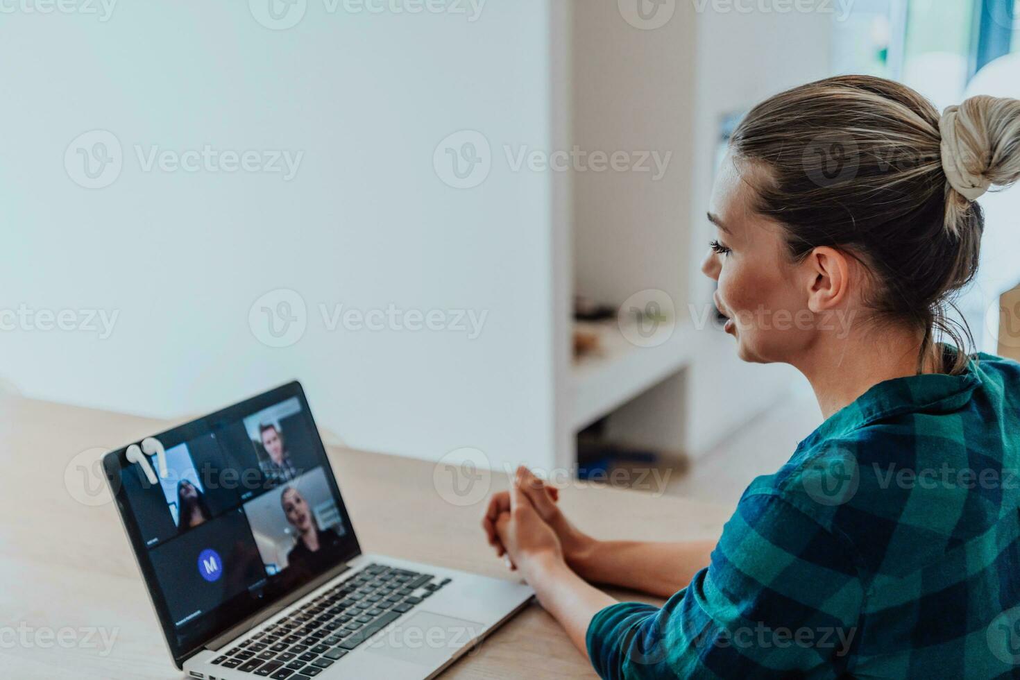 Woman sitting in living room using laptop look at cam talk by video call with business friend relatives, head shot. Job interview answering questions. photo