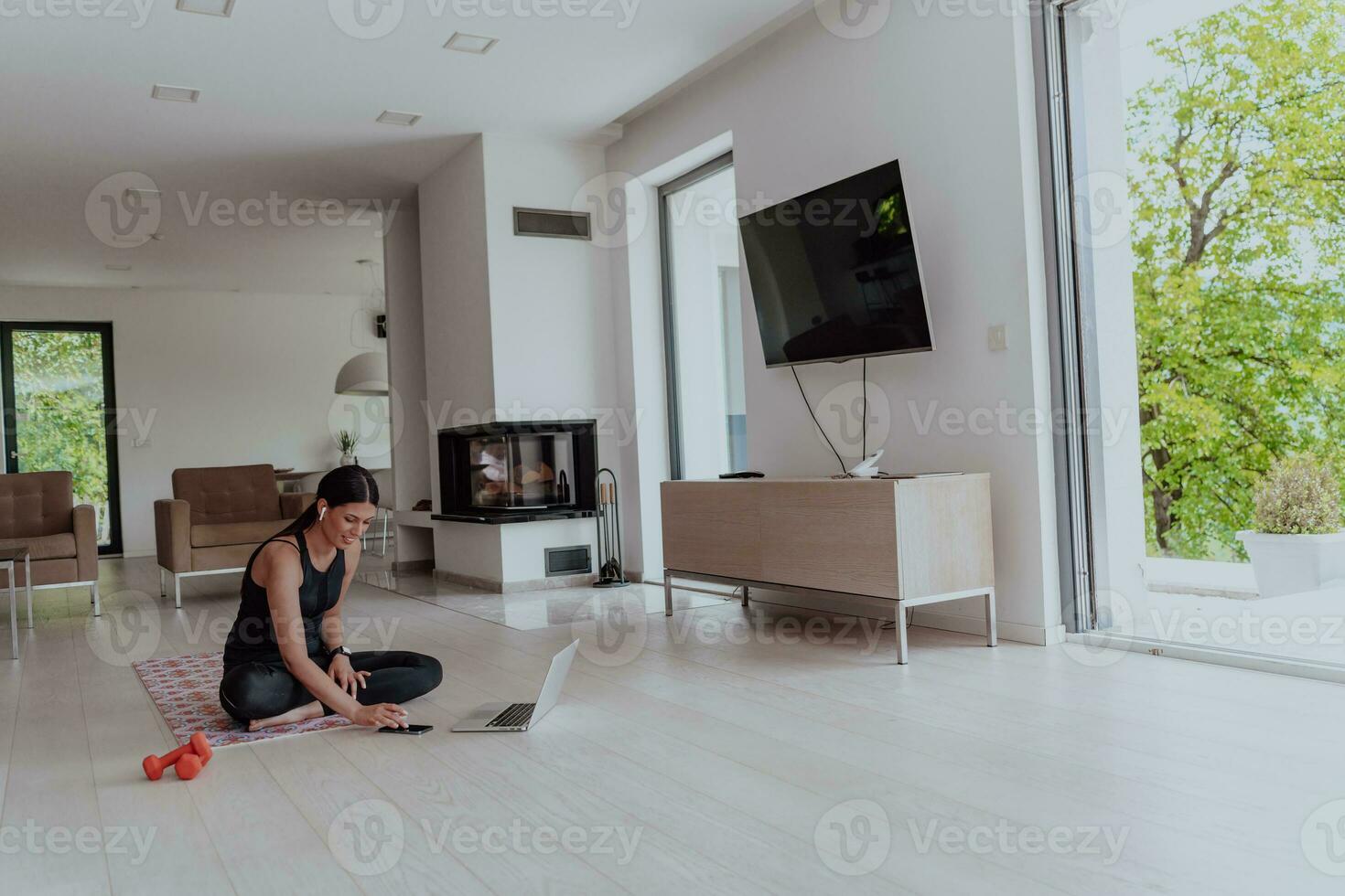 Young Beautiful Female Woman with Trainer via Video Call Conference in Bright Sunny House. Healthy Lifestyle, Wellbeing and Mindfulness Concept. photo