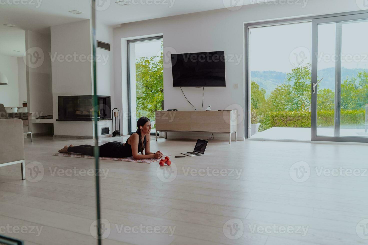 Young Beautiful Female Woman with Trainer via Video Call Conference in Bright Sunny House. Healthy Lifestyle, Wellbeing and Mindfulness Concept. photo