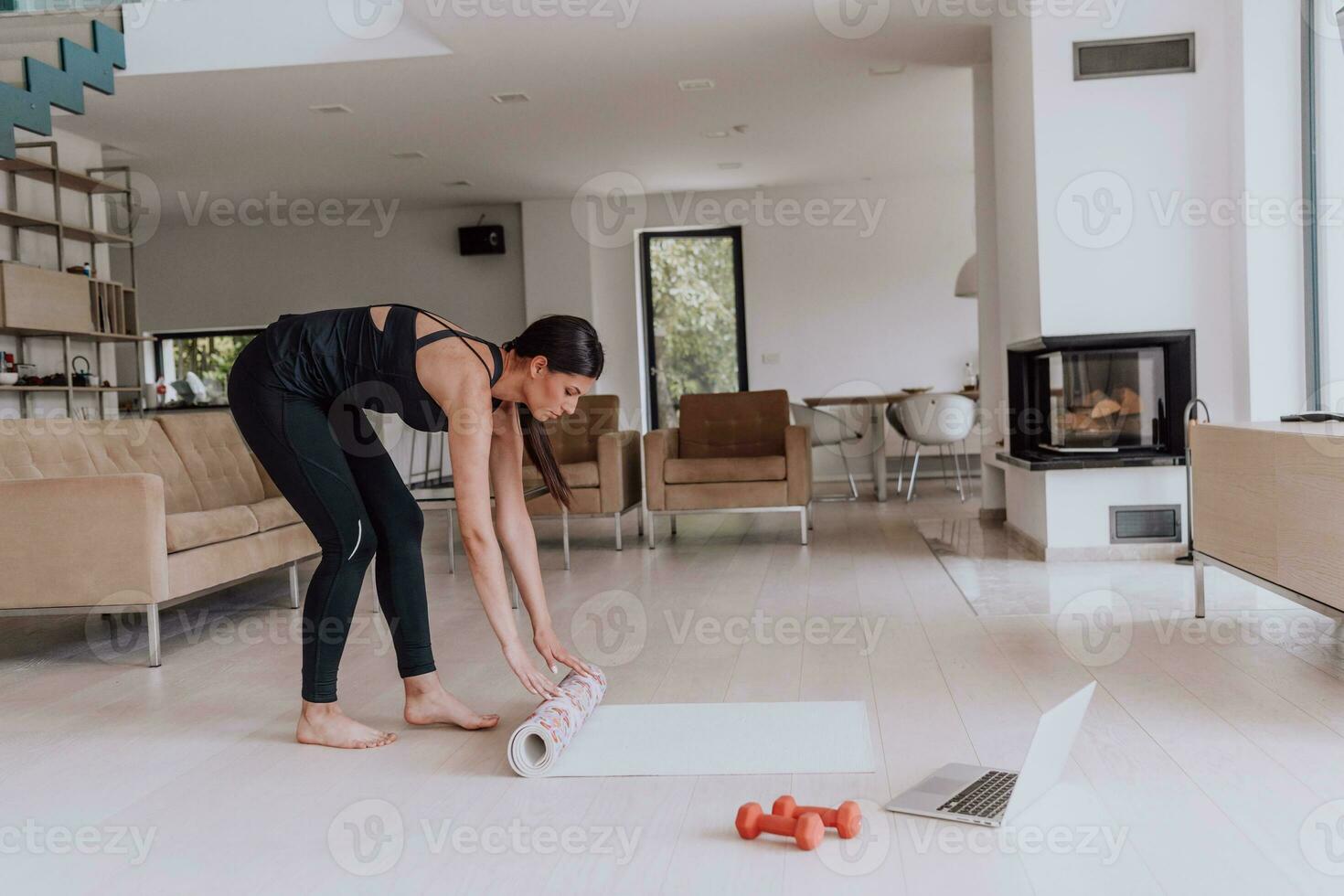 A young woman in sports clothes preparing sports equipment for