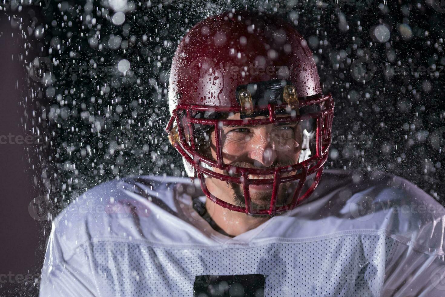American Football Field Lonely Athlete Warrior Standing on a Field Holds his Helmet and Ready to Play. Player Preparing to Run, Attack and Score Touchdown. Rainy Night with Dramatic Fog, Blue Light photo